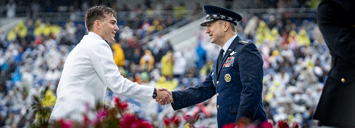 Chairman shakes hand with graduate